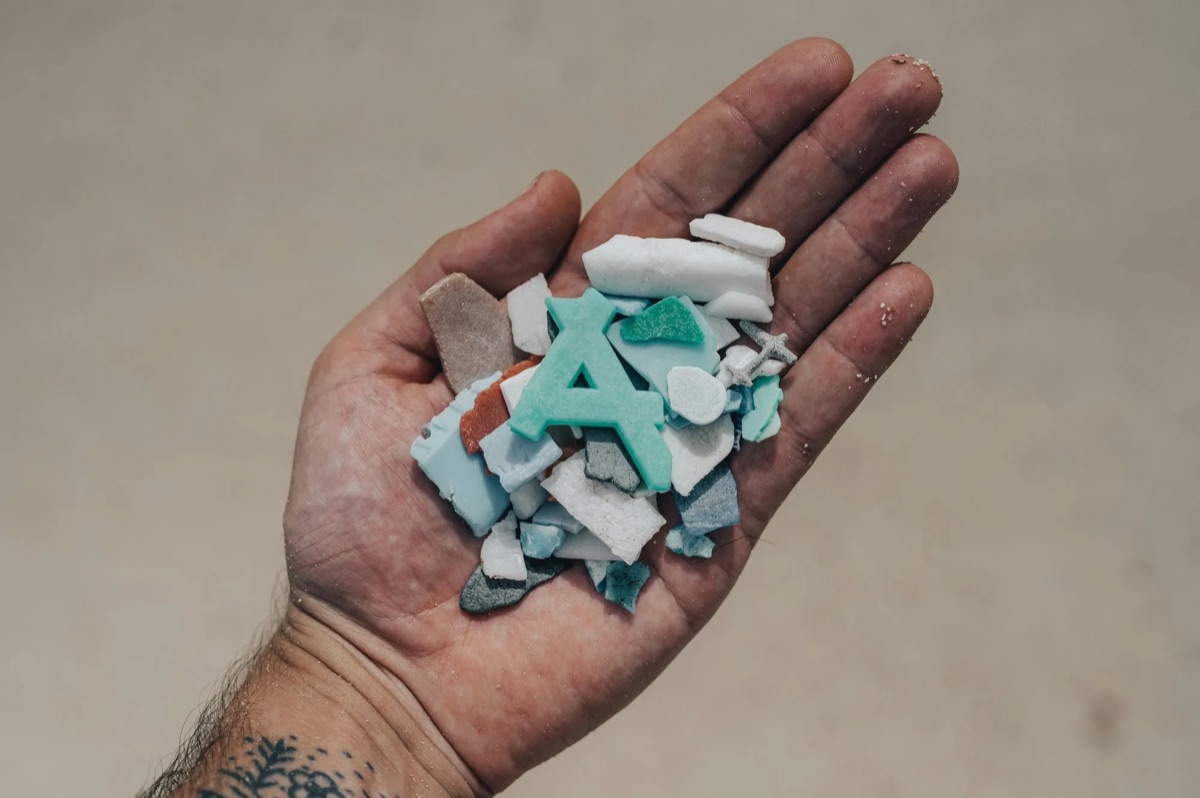 Hands holding recycled plastic flakes